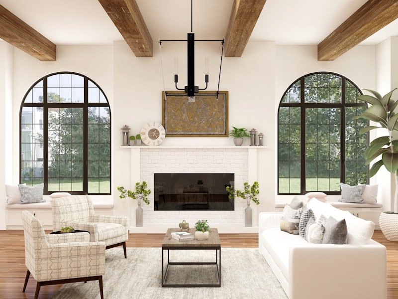 Whole-home renovation with exposed beams, fireplace, and arched windows