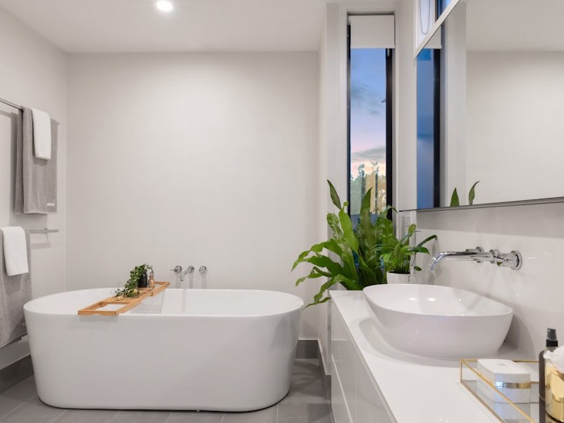 Luxury primary ensuite with freestanding tub and floor-to-ceiling windows